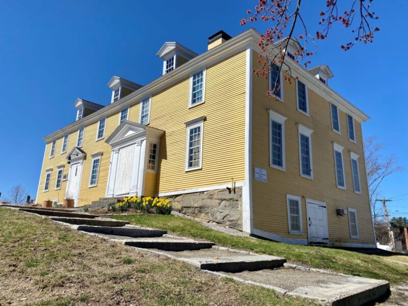 Image of a two story yellow colonial style house built in 1721