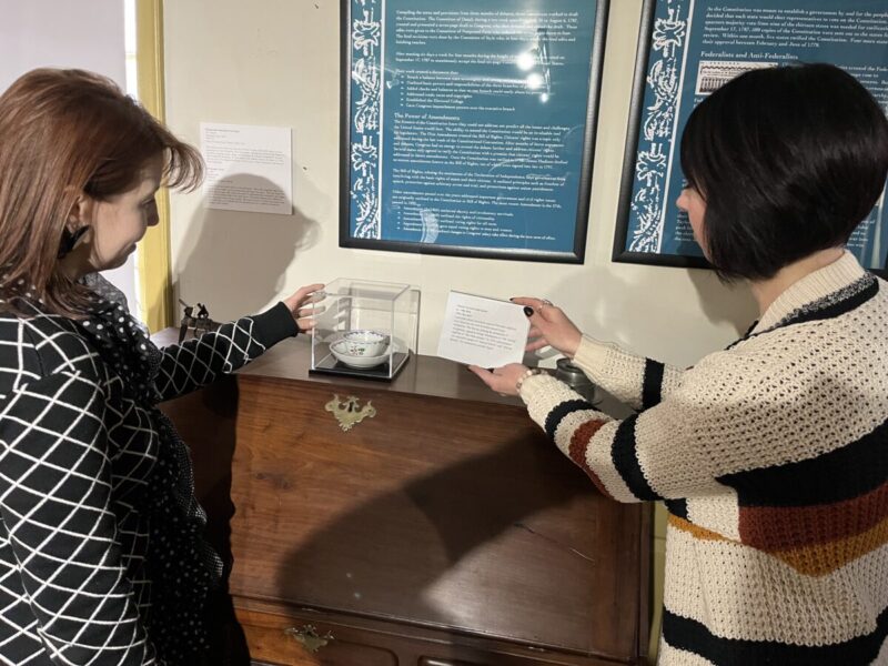 American Independence Center Staff looking at Indigenous artifacts in collection